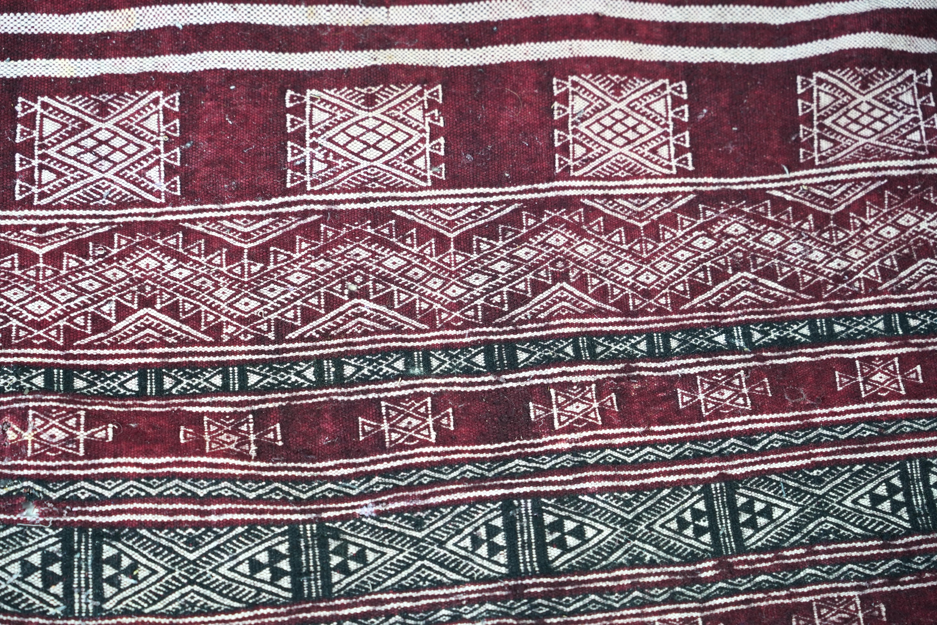 A Tunisian Amazigh, Berber maroon and white woven wool wall hanging, possibly 107 x 125cm